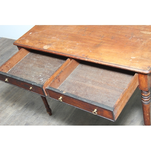 A 19th century mahogany two-drawer writing table with brass handles and ...