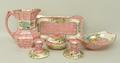 A quantity of Maling lustre pottery decorated in the Peony Rose pattern against a pink scale ground,... 