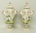 A pair of French faience pottery vases and covers, possibly Veuve Perrin, of baluster form, painted ... 