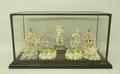 A porcelain montage, late 19th century, formed of five Continental bisque figures behind four porcel... 