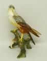 A Keramos, Hungary, porcelain figure of a falcon modelled perched on a branch, model number 2732, 28... 