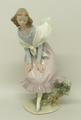 A Lladro porcelain figure of a 'Girl Bending', number 01005061, circa 1983, modelled by Vincente Mar... 