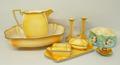 A Grimwades Royal Winton pottery wash jug and bowl with two candlesticks, soap and sponge dishes and... 