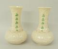 A pair of Belleek porcelain vases, third green mark, decorated in the Shamrock pattern against a mou... 
