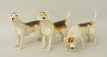 A set of Beswick pottery figures modelled as fox hounds. (3)