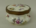 A Meissen porcelain box and hinged cover, late 19th century, of circular lobed form painted with spr... 