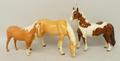 A Beswick Pinto pony skewbald, 17cm high, a Beswick Palomino pony, 12cm high, and a Sylvac Palomino ... 