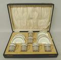 An Aynsley porcelain coffee set with pierced silver cup holders, Birmingham 1922, cased for Jay's of... 