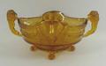 A Brockwitz amber glass bowl, circa 1930s, with twin lion handles, frosted panels moulded with acorn... 