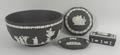 A Wedgwood black jasper fruit bowl, dressing table box and cover, small dish, and a powder bowl lid.... 