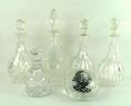 A pair of cut glass globe and shaft decanters with stoppers, 30cm high, three further cut glass deca... 