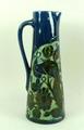 A Lauder Barum pottery jug, late 19th century, of out swept form sgrafitto decorated with a bird on ... 