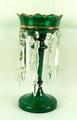 A Continental emerald green glass table lustre, late 19th century, the gilded body set with ten pris... 