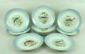 A set of ten J Pouyat, Limoges, porcelain plates, early 20th century, painted with fish within a tur... 