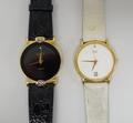 A Gucci lady's gilt metal cased quartz wristwatch, black dial, black leather strap, and a Citizen gi... 