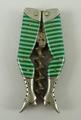 A novelty corkscrew, early 20th century modelled as a pair of lady's legs in striped green enamel.