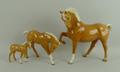 A Beswick figure of a palomino horse, no 1549 1st version, and two palomino foals, nos 1813 and 947.... 