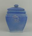 An Ashtead pottery tea caddy and cover, early 20th century, of square section moulded with the crest... 