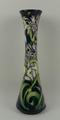 A Moorcroft pottery vase, circa 2003, of slender, waisted form decorated with woodland flowers again... 