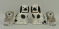 A pair of Staffordshire pottery figures modelled as seated spaniels, 10cm high, and a smaller pair o... 