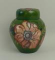 A Moorcroft pottery ginger jar and cover decorated in the 'Anemone' pattern against a green ground, ... 