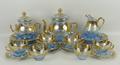 A Bohemian turquoise glass part tea service, early 20th century, with gilt overlay and enamel floral... 