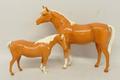 A Beswick pottery model of a palomino horse, 19cm high, and another of a palomino pony, 12cm high.
