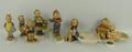 A group of Hummel pottery figures comprising a skier 59, Village Boy, Little Helper, Little Hiker, L... 