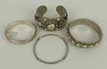 A group of bangles, comprising two silver bangles, 0.915toz, and two further Thai bangles with raise... 