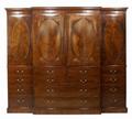 A large and impressive Regency flame mahogany breakfront compactum wardrobe in three sections, inlai... 