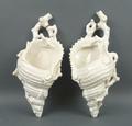 A pair of Royal Worcester white glazed porcelain wall pockets, circa 1889, modelled as conch shells,... 