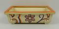 A Clarice Cliff Bizarre rectangular planter, hand painted with flowers, printed mark to base and imp... 