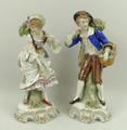 A pair of Continental porcelain figures of flower sellers, each raised on a rococo scroll base, 24cm... 