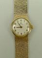 A lady's 9ct gold Omega wristwatch, with woven gold strap, gold hands and Arabic numerals.