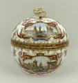 A Helena Wolfson porcelain circular box and cover, with rose finial, decorated in the manner of Hero... 