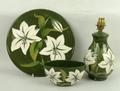 A Moorcroft pottery dish decorated in the 'Bermuda Lily' pattern, 30cm diameter, together with a bed... 