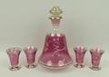 A Continental pink glass decanter and four glasses, circa 1950's, with pink resist and etched floral... 