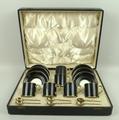 An Allertons porcelain coffee set decorated in black with faux skin, gilt highlighted, comprising si... 