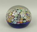 A glass millefiori paperweight, late 19th century, with concentric canes against a blue ground, 9.5c... 