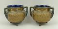 A pair of Royal Doulton stoneware vases, circa 1904, of cauldron form decorated with gilt swirls and... 