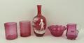 A quantity of cranberry glass, comprising; a Mary Gregory bud vase, 22cm high, two tumblers, a jug, ... 