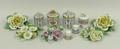 A group of five Dresden porcelain floral ornaments, four cylindrical boxes and covers with floral kn... 