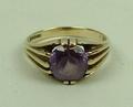 A 9ct gold and amethyst ring, the central circular amethyst in a ten prong claw setting, approx 2cts... 