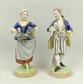 A pair of Dresden porcelain figures, 20th century, modelled as a gentleman taking snuff, and a woman... 