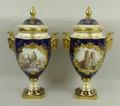 A pair of Coalport porcelain vases and covers of twin ram's head handled baluster form, one painted ... 
