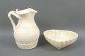 A Belleek porcelain jug, first black mark, with herringbone moulding above a band of shamrock, 14cm,... 
