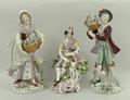 A Sampson Derby porcelain figure, late 19th century, modelled as a piper boy with dog seated amongst... 