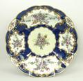 A Worcester, First Period, fluted dish reserve decorated with panels of flowers against a blue scale... 