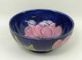 A Moorcroft pottery bowl decorated in the 'Magnolia' pattern against a cobalt blue ground, monogramm... 