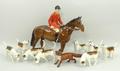 A Beswick pottery figure of a huntsman, eight hounds, and a fox. (10)